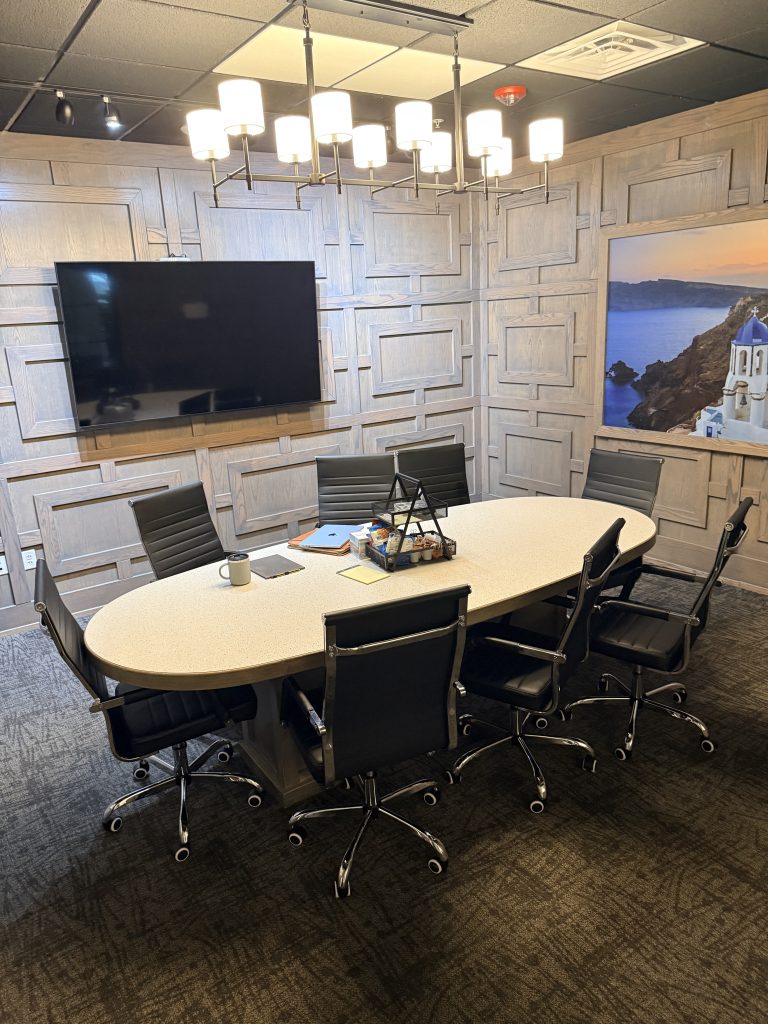 Wood-paneled mediation room at the Allen office, with snacks set out on the table